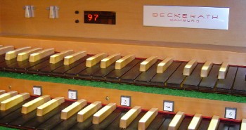 Organ console showing sequencer display and piston buttons