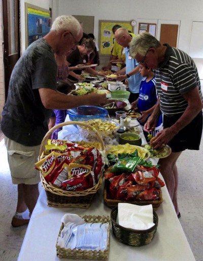 Members and friends making their way through the food line