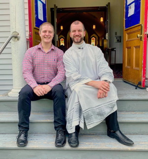 Almost-Pastor Andy and Justin on the steps of Emmaus Lutheran