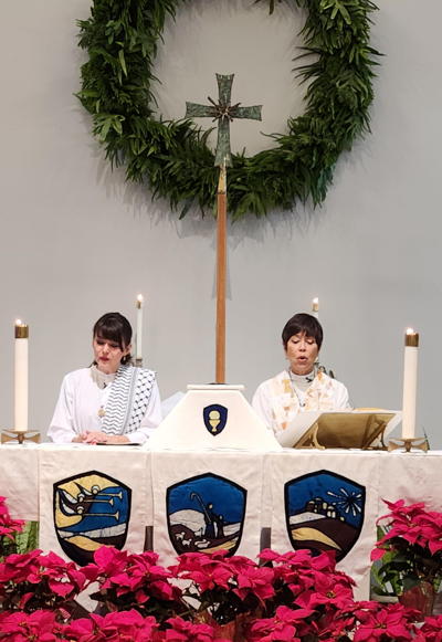 Pr. Margrethe and Assisting Minister Willow Chang at the altar on Christmas Eve