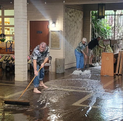 Working together to get the overflow of water from the another Hawaiian downpour in the Hörmann Courtyard.