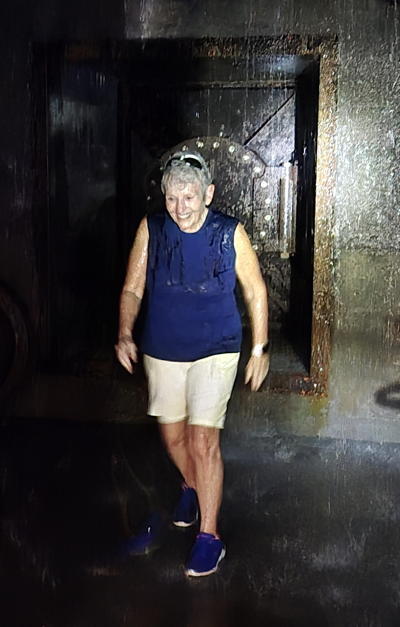 Cindy Scheinert enjoying the falling water at the back of the e Tunnel.