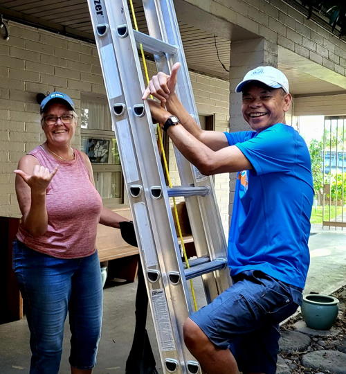 Jean Lilley and Rudy Riingen helping clear out the rain gutters.