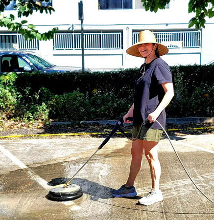 Maxine Miller power washing our church parking lot.