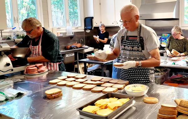 Roy Helms and Pr. Jeff keeping the sandwich making line going! LCH volunteers serve once a month in preparing sack lunches for IHS.