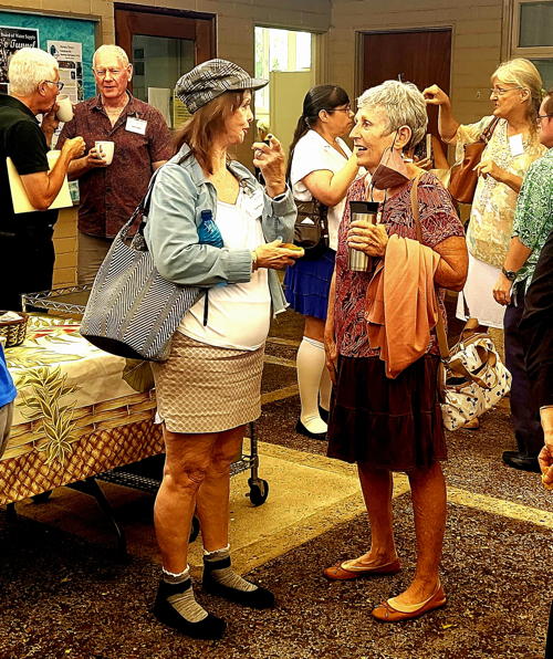 Cindy Scheinert and Nan Wond catching up in the courtyard