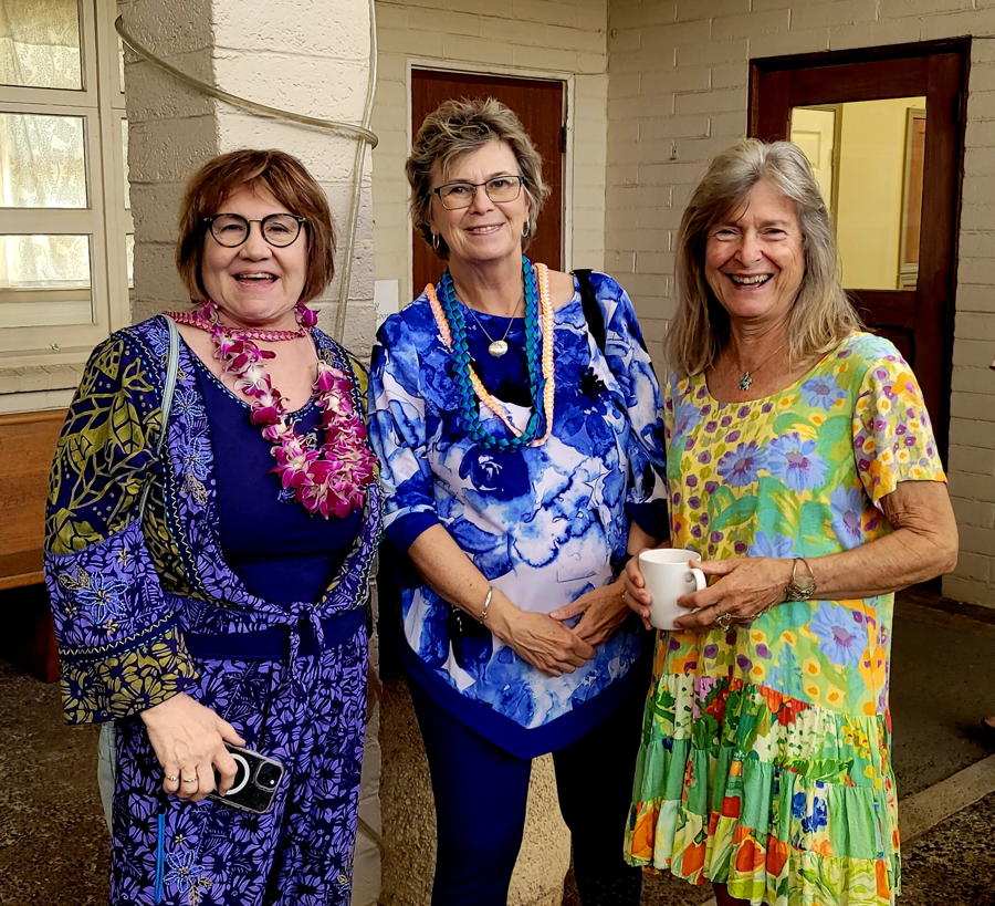 Paula Wheeler and new visitors share a welcoming time after a worship servce.