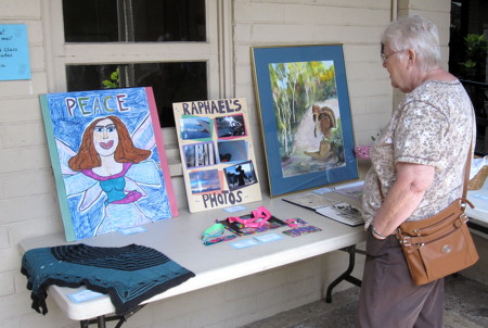 A member looks at examples of the art work of children and adults submitted as part of the annual Faith and Arts Sunday