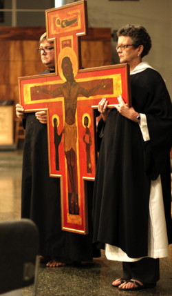 Pastor jeff Lilley and Deacon Mary Fastenau carrying the cross during the Procession of the Cross.