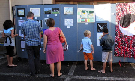 Members look at examples of the art work of children and adults submitted as part of the annual Faith and Arts Sunday