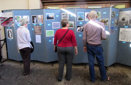 Members look at examples of the art work of children and adults submitted as part of the annual Faith and Arts Sunday