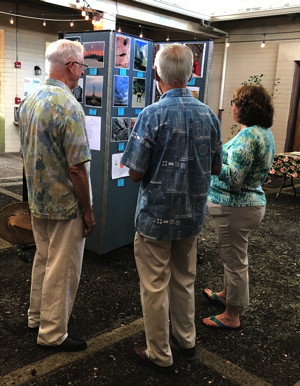 Members look at examples of the art work of children and adults submitted as part of 2016’s annual Faith and Arts Sunday