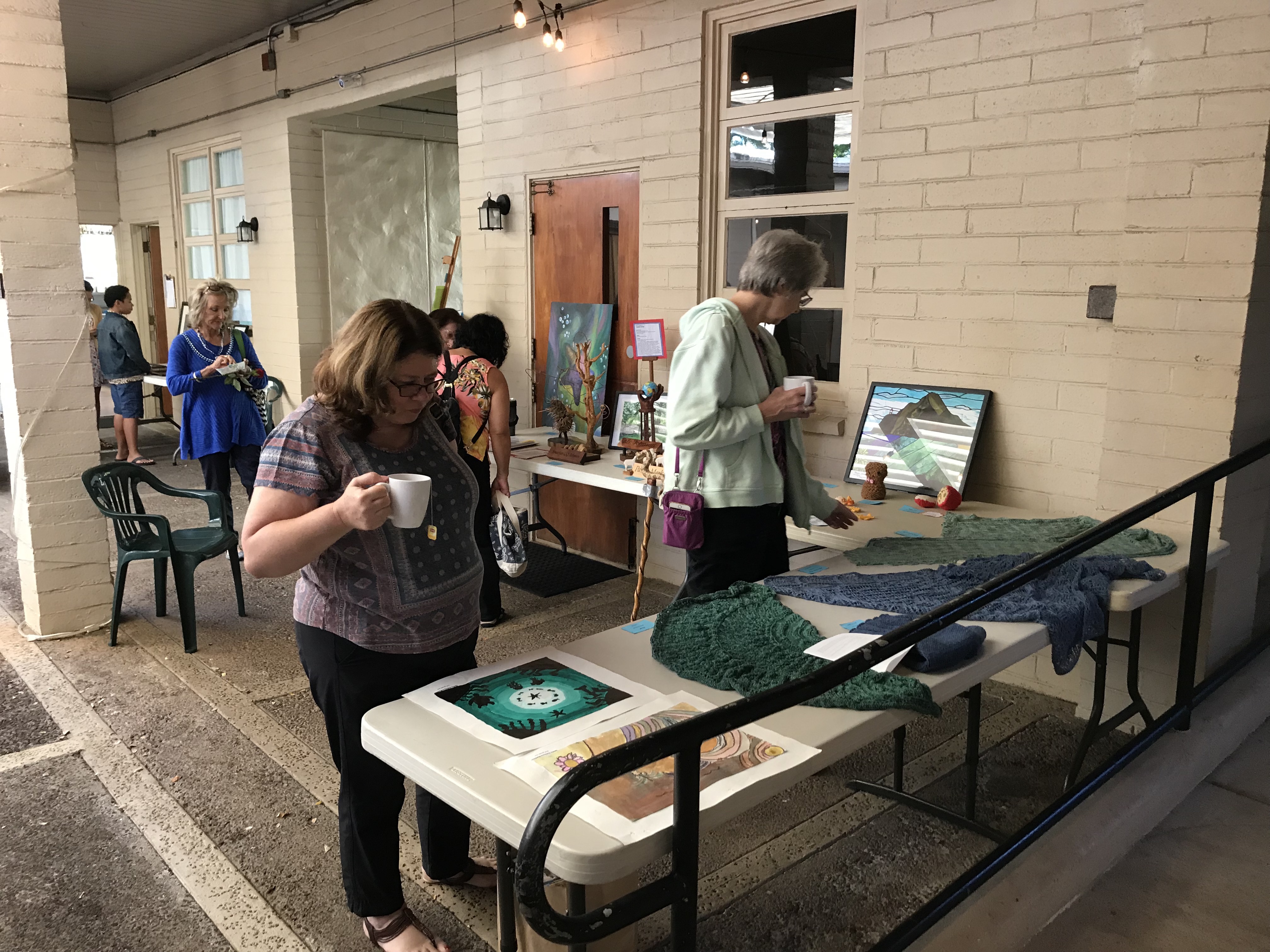 Members look at examples of the art work of children and adults submitted as part of 2017’s annual Faith and Arts Sunday