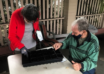 Josie Bidgood and Chuck Pearson plant seeds