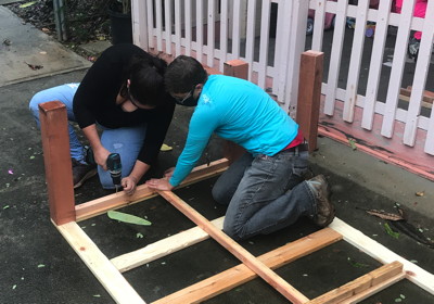 Vicar Bree and Jazz assemble the frame for the garden