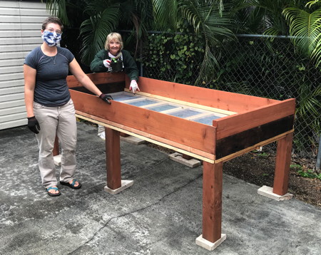 Peggy Anderson and Vicar Bree check out the planting bed