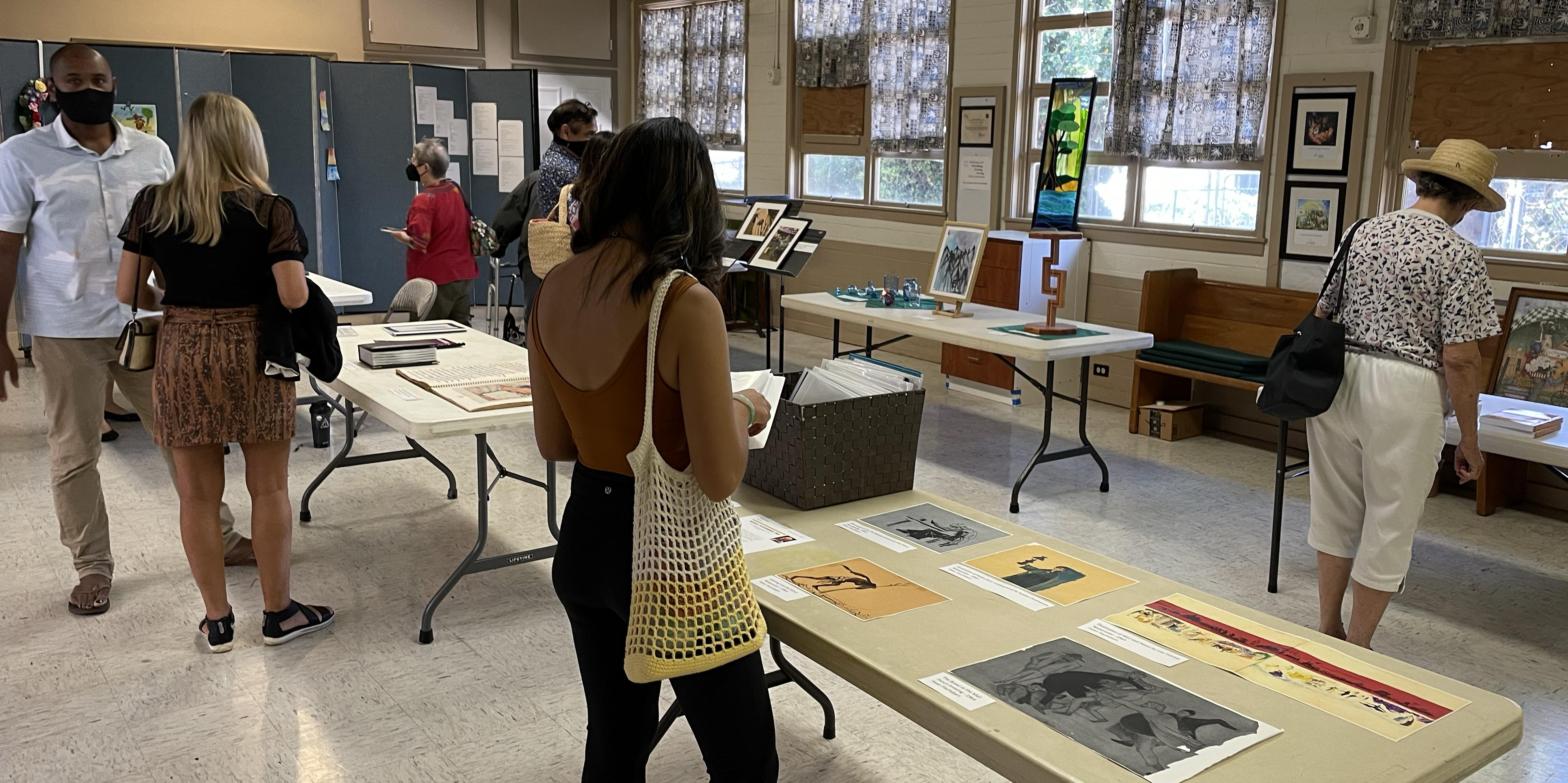 Members look at examples of the art work of children and adults submitted as part of 2022’s Faith and Arts Sunday