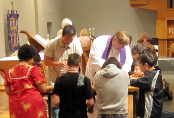 Serving communion at the altar rail