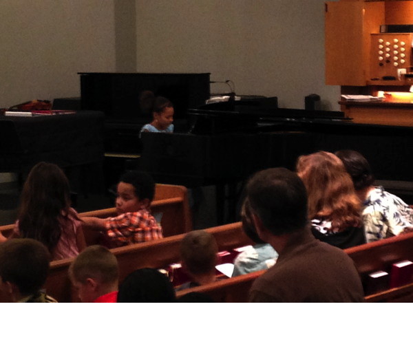 A girl plays the prelude.