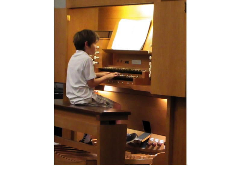 A boy played “Toccotina” by David Schaap on the organ.