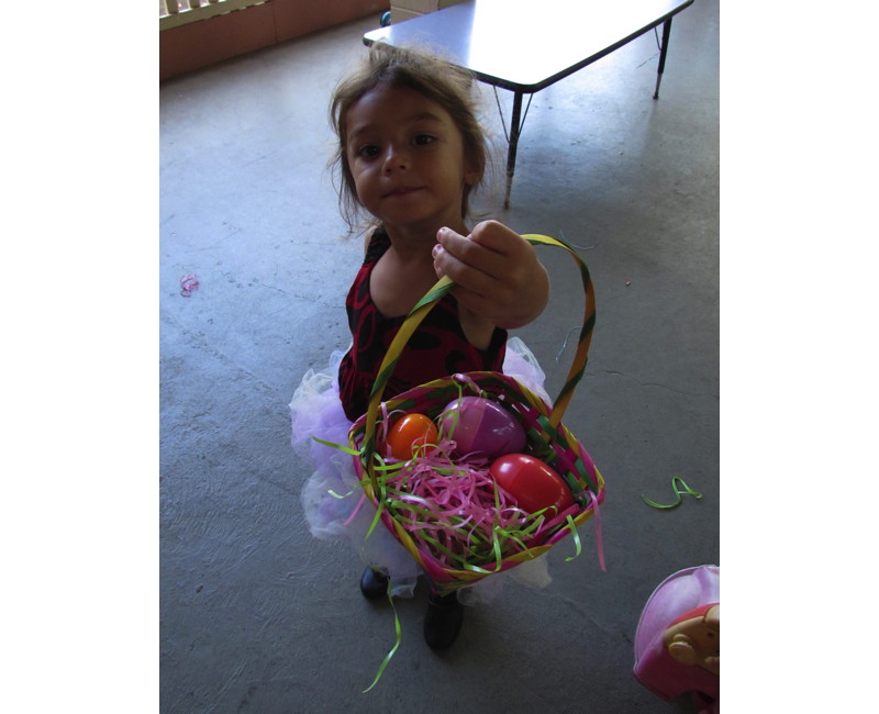 A girl with her basket of Easter eggs