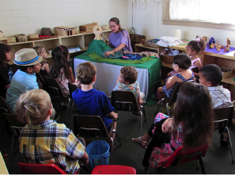 The younger children enjoy a puppet show while the older children hide the Easter eggs