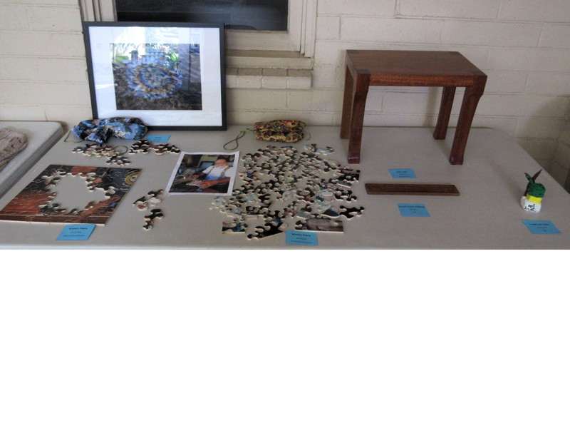 Items Displayed at Faith and Arts Sunday (clockwise from top left)—“Arizona” (photograph) by Richard Cook; “Side Table” (Broken LCH pew) and “Carved Travel Cribbage” (teak) by Jeff Lilley; “Trophy for Nana” (clay) by Azure Sueda; “Winnie’s Family” (Wooden puzzles and photo) by Don Johnson