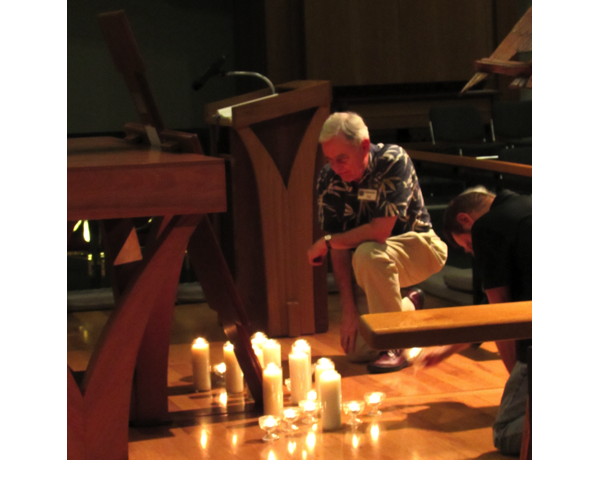 Worshippers brought candles and knelt before the cross.