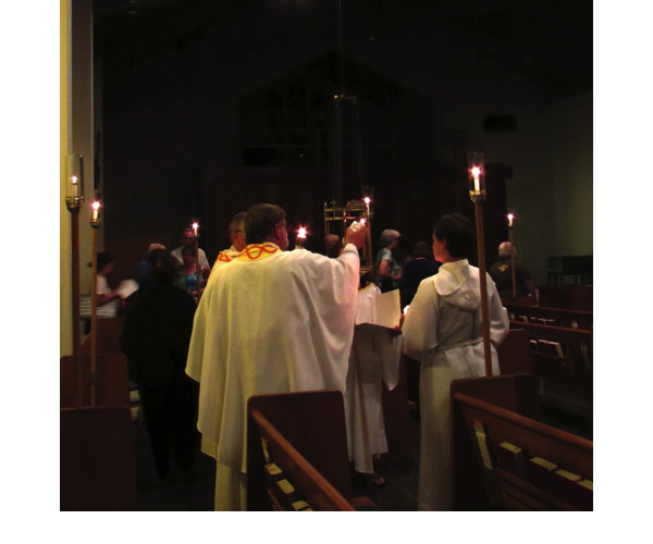 The ministers led the congregation into the Nave and lit the presence candle before the Easter proclamation.